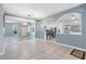 Spacious living area with open archways, tiled flooring, and expansive mirrors, connecting the living spaces seamlessly at 3203 Audubon Ct, Tarpon Springs, FL 34688