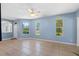 Open living area with tile floors, multiple windows offering natural light, and neutral walls ready for personalization at 3203 Audubon Ct, Tarpon Springs, FL 34688