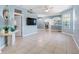 An open-concept living room featuring light blue walls, tile floors, and lots of natural light from the windows at 3203 Audubon Ct, Tarpon Springs, FL 34688