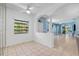 Bright living room with tile floors, neutral paint and large windows at 3203 Audubon Ct, Tarpon Springs, FL 34688
