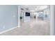 Open-concept living room with tile flooring, columned arches and neutral paint at 3203 Audubon Ct, Tarpon Springs, FL 34688