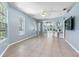 Expansive living room showcasing tile flooring, large windows, and a seamless transition to the outdoor area through sliding doors at 3203 Audubon Ct, Tarpon Springs, FL 34688