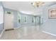 Bright living room with tile flooring, large windows and a chandelier at 3203 Audubon Ct, Tarpon Springs, FL 34688