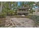Backyard with a wooden structure and stone patio at 512 Acacia Ln, Nokomis, FL 34275