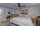 Spacious bedroom with mirrored closet doors and ceiling fan at 512 Acacia Ln, Nokomis, FL 34275