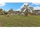 Single story home with palm trees and a large yard at 512 Acacia Ln, Nokomis, FL 34275