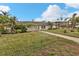 Ranch style home with a spacious lawn and walkway at 512 Acacia Ln, Nokomis, FL 34275