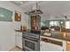 Kitchen with granite countertops, stove, and partial view of living room at 512 Acacia Ln, Nokomis, FL 34275