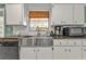 Kitchen features granite countertops, stainless steel sink, and modern appliances at 512 Acacia Ln, Nokomis, FL 34275