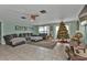 Spacious living room featuring a sofa, ottoman, and a Christmas tree at 512 Acacia Ln, Nokomis, FL 34275