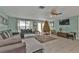 Living room with tiled floor, sectional sofa, and Christmas tree at 512 Acacia Ln, Nokomis, FL 34275