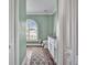 Elegant bathroom with a toilet, vanity, and an arched window with shutters at 5156 Mentmore Ave, Spring Hill, FL 34606