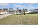 Gray house with a three-car garage and large front yard at 5156 Mentmore Ave, Spring Hill, FL 34606