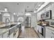 Modern kitchen with stainless steel appliances and granite countertops at 5156 Mentmore Ave, Spring Hill, FL 34606
