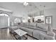 Open concept living room with sectional sofa and view of kitchen at 5156 Mentmore Ave, Spring Hill, FL 34606