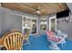 Covered patio with wooden table and seating at 5156 Mentmore Ave, Spring Hill, FL 34606