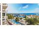 Beautiful view of the community pool with palm trees and luxury residential buildings in the background at 5701 Bowen Daniel Dr. # 402, Tampa, FL 33616
