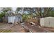 Backyard with sheds and various yard clutter at 6404 Pershing Ne St, St Petersburg, FL 33702