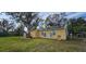 Yellow house with green trim, needs exterior work and has solar panels at 6404 Pershing Ne St, St Petersburg, FL 33702