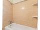 Bathroom with beige tile, shower, and bathtub at 6415 Sandpiper S Way, St Petersburg, FL 33707