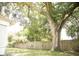 Large backyard with a mature oak tree and wooden fence at 6741 Willits Ave, New Port Richey, FL 34655