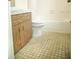 Clean bathroom with wood vanity and tile floor at 6741 Willits Ave, New Port Richey, FL 34655