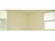 Simple bedroom with two windows and light walls at 6741 Willits Ave, New Port Richey, FL 34655