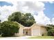 Front view of a one story house with a garage and landscaping at 6741 Willits Ave, New Port Richey, FL 34655