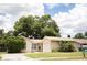 One-story house with attached garage, driveway, and mature landscaping at 6741 Willits Ave, New Port Richey, FL 34655