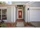 Red front door entry with brick walkway leading to the house at 7511 Savannah Ln, Tampa, FL 33637