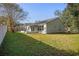 House exterior with grassy yard and screened porch at 7511 Savannah Ln, Tampa, FL 33637