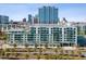 Modern building exterior with multiple balconies, lush landscaping, and city skyline views at 912 Channelside Dr # 2601, Tampa, FL 33602