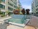 Inviting community hot tub surrounded by lush plants and modern architecture, perfect for relaxation at 912 Channelside Dr # 2601, Tampa, FL 33602