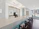 Stylish kitchen bar featuring a stone countertop, seating, and a full view of the kitchen appliances at 912 Channelside Dr # 2601, Tampa, FL 33602