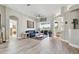 Spacious living room featuring a blue sofa and large windows at 9202 Everwood Ct, Tampa, FL 33647