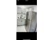 Updated kitchen with gray cabinets and stainless steel refrigerator at 11511 Meredith Ln, Port Richey, FL 34668