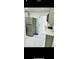Modern kitchen features stainless steel appliances and gray cabinets at 11511 Meredith Ln, Port Richey, FL 34668