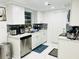 Clean and efficient kitchen with white cabinets and stainless steel appliances at 11511 Meredith Ln, Port Richey, FL 34668