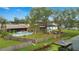Aerial view of fenced backyard with a pool, and a dock on the canal at 1307 Windjammer Pl, Valrico, FL 33594