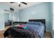 Bedroom with light blue walls, a ceiling fan, and sliding mirror closet doors at 1307 Windjammer Pl, Valrico, FL 33594