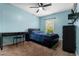 Bedroom with a ceiling fan, light blue walls, and a window with blinds at 1307 Windjammer Pl, Valrico, FL 33594