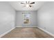 Bedroom featuring neutral walls, a ceiling fan, and a window providing natural light at 1307 Windjammer Pl, Valrico, FL 33594