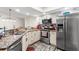 Bright kitchen featuring granite countertops, stainless steel appliances, and ample cabinet space at 1307 Windjammer Pl, Valrico, FL 33594