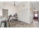 Bright living room boasts unique wood-look floors, a coffee bar, and front door access at 1307 Windjammer Pl, Valrico, FL 33594