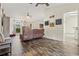 Open-concept living space featuring wood-look floors and cozy seating area at 1307 Windjammer Pl, Valrico, FL 33594