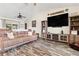 Comfortable living room featuring stylish flooring, a large television, and cozy seating at 1307 Windjammer Pl, Valrico, FL 33594