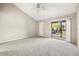 Spacious bedroom with vaulted ceiling and access to balcony at 14625 Par Club Cir, Tampa, FL 33618