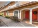 Exterior view of townhouse with red door and landscaping at 14625 Par Club Cir, Tampa, FL 33618