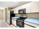 Bright kitchen features stainless steel appliances and light blue countertops at 14625 Par Club Cir, Tampa, FL 33618