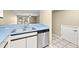Kitchen features a light blue countertop, stainless steel sink and dishwasher at 14625 Par Club Cir, Tampa, FL 33618
